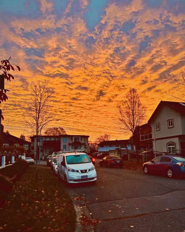 Orange morning clouds over a quiet street, 7:00