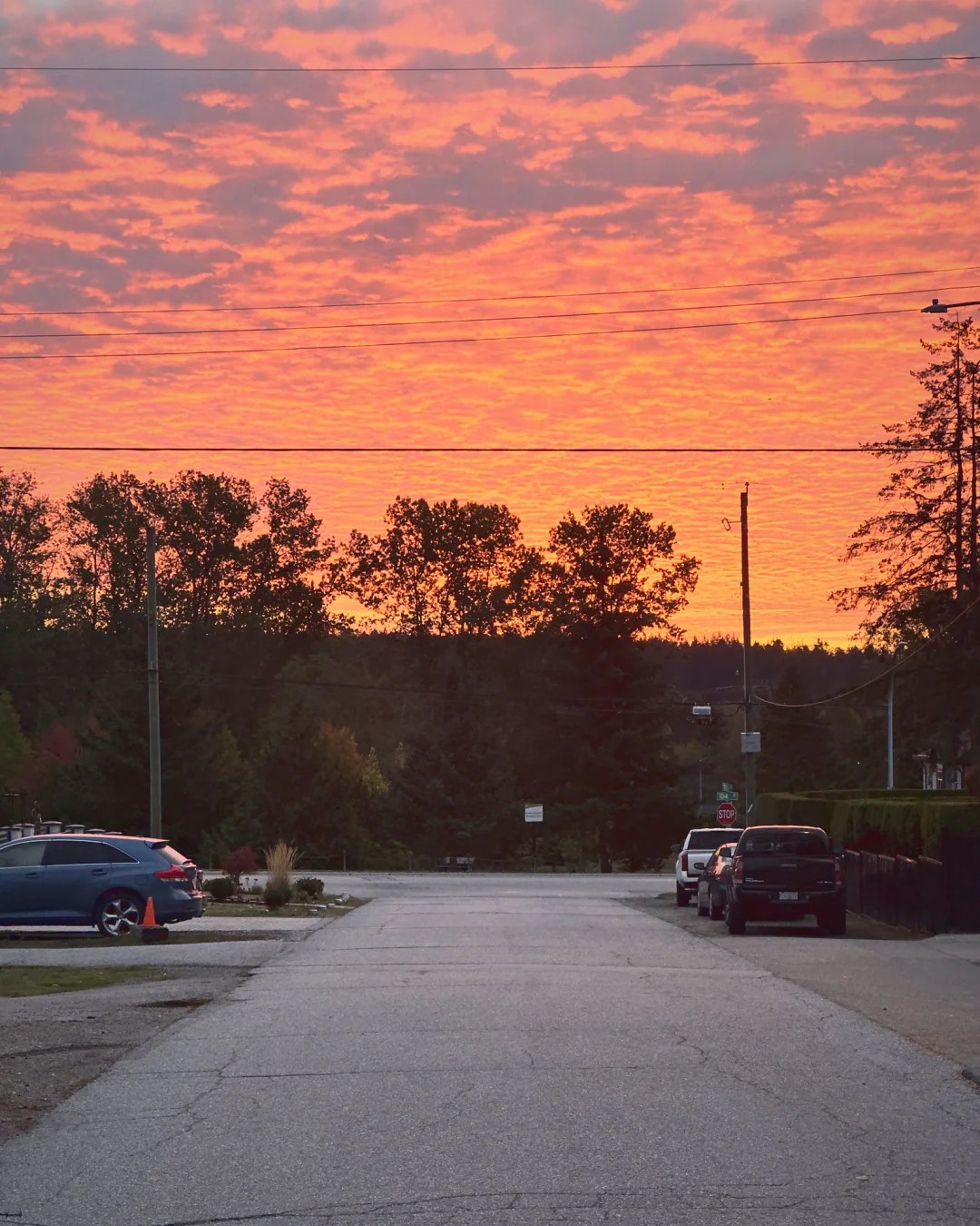 Pink morning clouds over a street, 7:02