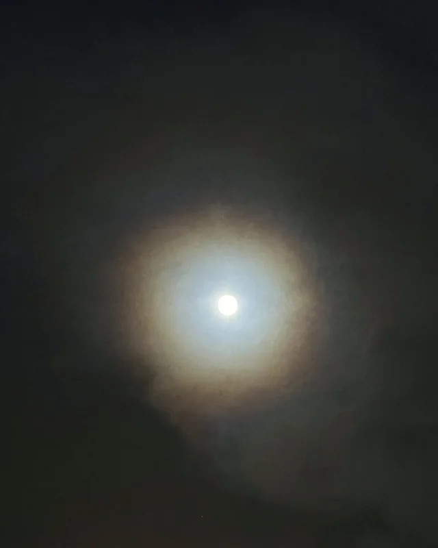 The moon with a halo in a dark sky