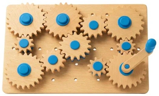 A wooden board of interlocking gears with blue hubs.
