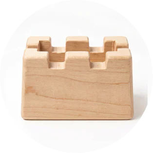 A wooden castle block with a notched top.