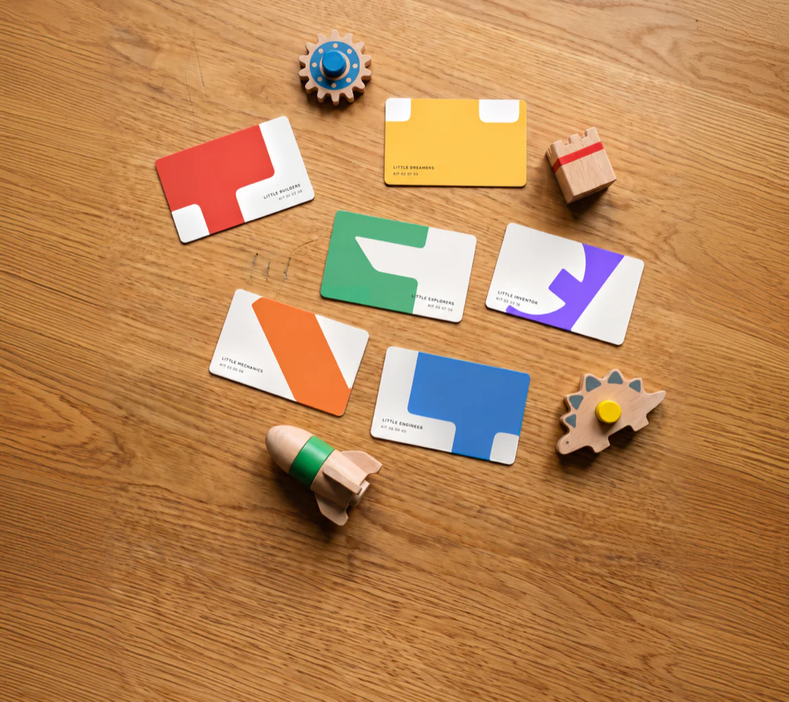 A set of white business cards with the letter shapes.